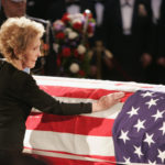 Mrs. Reagan touches the coffin of her husband during his state funeral on Capitol Hill on June 9, 2004. Ronald Reagan died after a long struggle with Alzheimer's disease. AP
