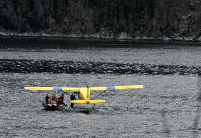 Passenger Richard Hudler of Anchorage is loaded into a boat from the temporarily-disabled float plane. The plane, owned by Alaska Seaplanes, made an emergency landing in Lutak Inlet late Wednesday morning. No injuries were reported. (Photo by Jillian Rogers/KHNS)