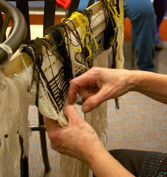 Ravenstail involves several intricate and complex weaving techniques, which Parker displayed for an eager crowd of local fiber artists. (Photo by Jenny Neyman/KDLL)