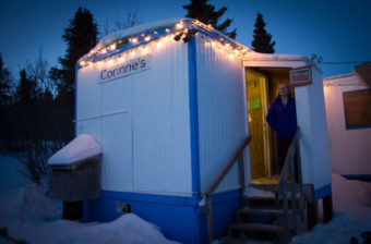 Corinne Trish outside her shop in Koyuk. (Photo by Emily Russell/KNOM)
