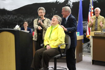 Former Juneau mayor Sally Smith presents Kim Kiefer with $50. (Photo by Elizabeth Jenkins/KTOO)