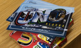 A postcard reading "Greetings from Uno Alaska" (Photo by David Purdy/KTOO)