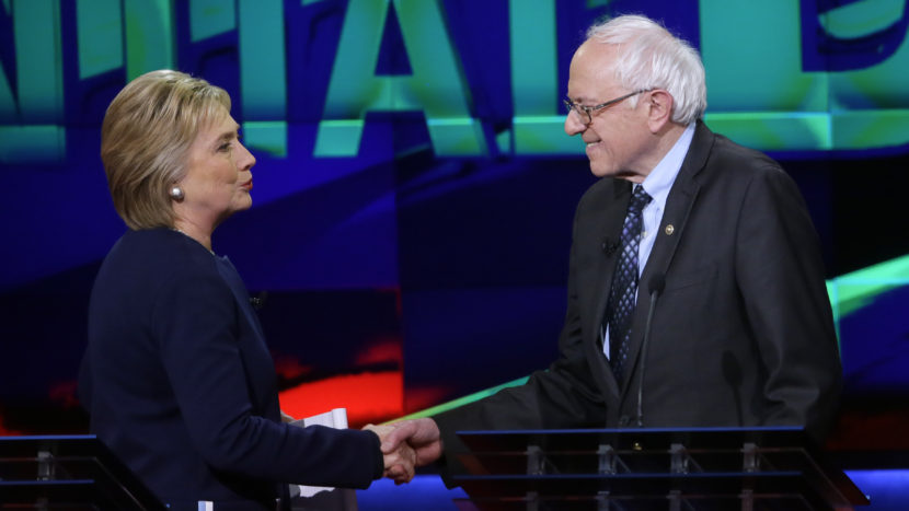 Hillary Clinton and Bernie Sanders shake hands at the end of a Democratic presidential primary debate last month. (Carlos Osorio/AP)