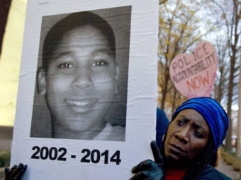 A protester holds up a picture of 12-year-old Tamir Rice in a December 2014 demonstration in Washington, D.C. Jose Luis Magana/AP