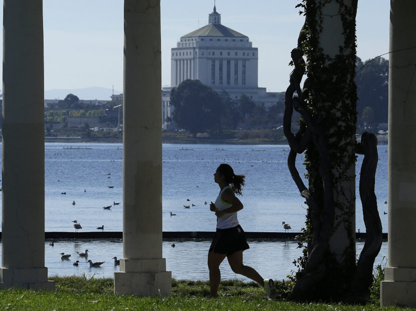A woman jogs in Oakland, Calif., last February. Healthier lifestyles may be a reason why poor people live longer in some cities than others. Ben Margot/AP
