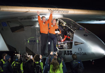 Solar Impulse 2 pilots Bertrand Piccard (right) and Andre Borschberg celebrate after Piccard landed their solar-powered plane at Moffett Field in Mountain View, Calif., on Saturday. Noah Berger/AP