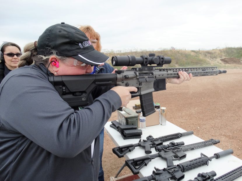 Robyn Sandoval, executive director of A Girl & A Gun, aims a rifle. Courtesy of A Girl and A Gun