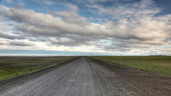 Technologies used to preserve permafrost under roads around Fairbanks may within a few decades be better-suited for areas farther north, such as the 414-mile Dalton Highway, which stretches off to the south in this photo taken near its northern terminus at Deadhorse. (KUAC file photo)