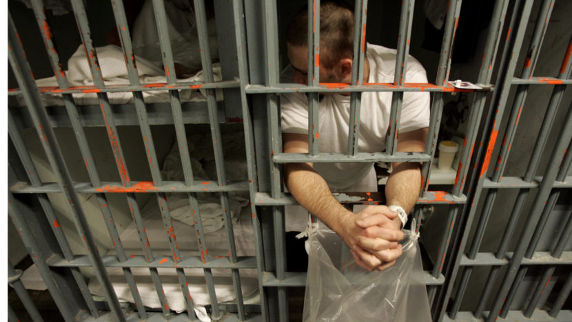 An inmate leans out the bars of his cell in a one-prisoner-per-cell block in downtown Los Angeles. Brian Vander Brug/LA Times via Getty Images