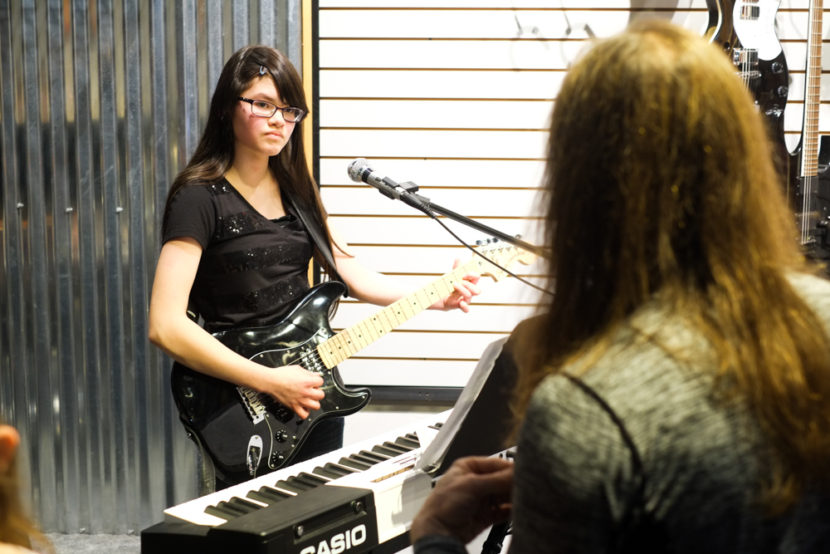 Ward F. Ward instructs Nicole Adams on guitar at Alaska Music One. (Photo by Annie Bartholomew/KTOO)