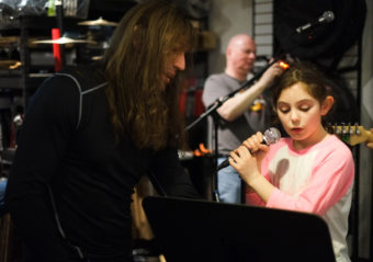 Instructor Ward F. Ward and daughter Cadence Ward rehearse with School of Rock Sessions band 3, 2, 1... at Alaska Music One. (Photo by Annie Bartholomew/KTOO)