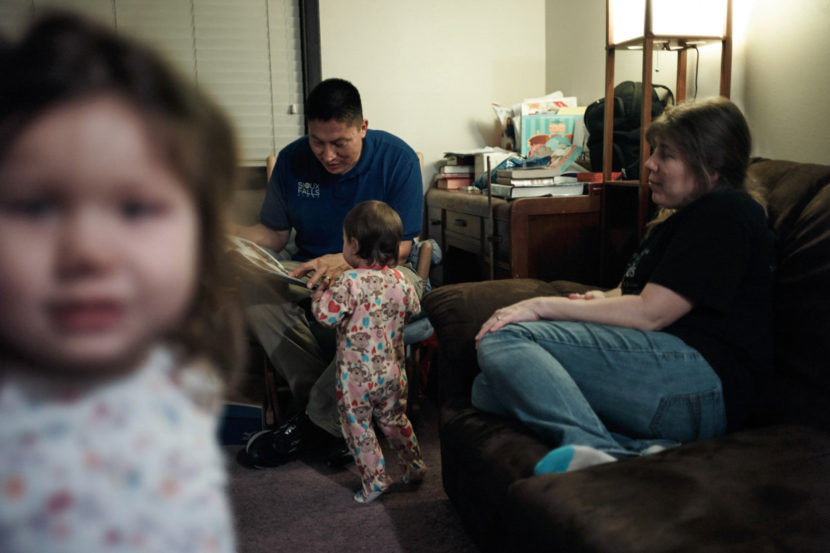 Joe Marrowbone left the reservation and moved to Sioux Falls for a job. He and his wife, Connie, play with daughters Grace and Alicia. Misha Friedman for NPR