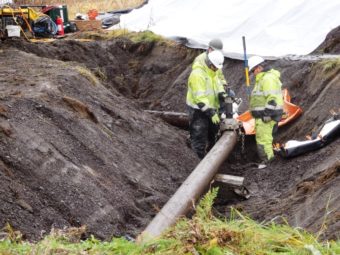 Workers test for residual fluid in a section of pipeline at the former fuel terminal. The Army is removing all 15,000 linear feet of pipeline at the fuel terminal as part of the effort to address the long-standing contamination there. (Photo by Emily Files/KHNS)