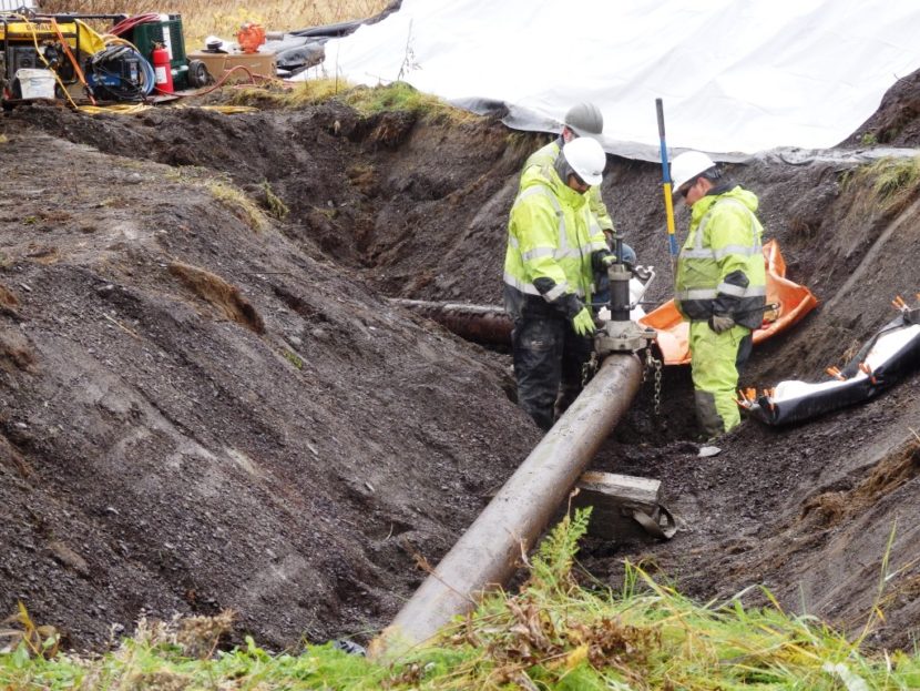 Workers test for residual fluid in a section of pipeline at the former fuel terminal. The Army is removing all 15,000 linear feet of pipeline at the fuel terminal as part of the effort to address the long-standing contamination there. (Photo by Emily Files/KHNS)