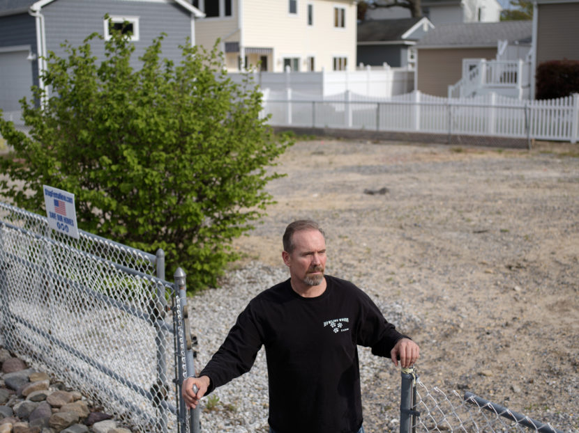 Doug Quinn stands on the empty lot where his house used to be. Bryan Thomas for NPR