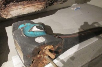 A large fragment from the Chief Kyan Totem Pole showing a metal rod repair. (Photo by Maria Dudzak/KRBD)