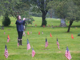 The playing of Taps concludes Memorial Day observances at Evergreen Cemetary.