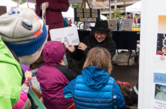Children listen to a story at the 2016 Juneau Maritime Festival (Photo by David Purdy/KTOO)