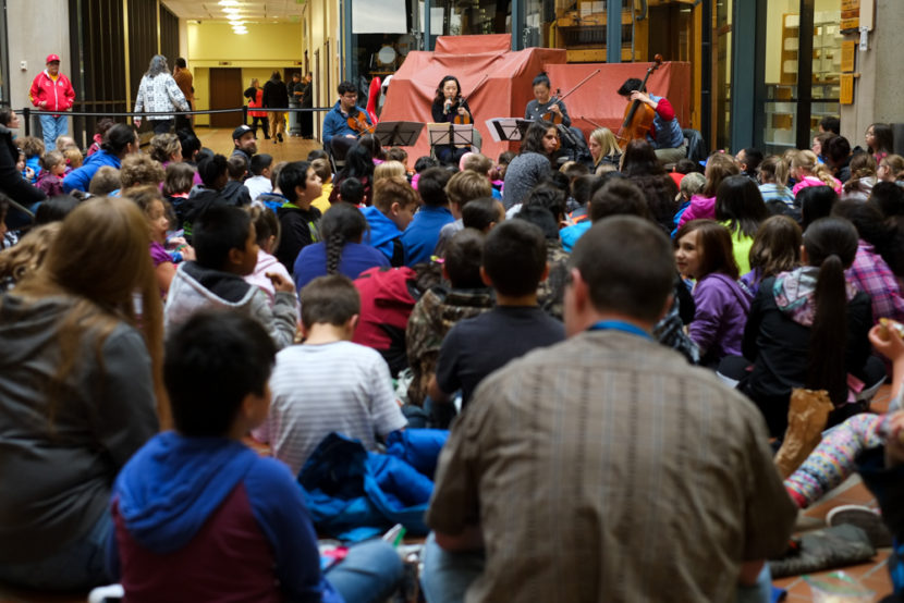 The Vega String Quartet performed for nearly 200 school children at the State Office Building Atrium, Monday, May 9. (Photo by Annie Bartholomew/KTOO) 