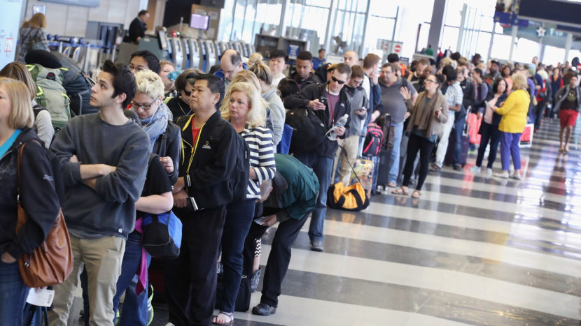 Passengers wait in line to be screened at a Transportation Security Administration checkpoint at Chicago's O'Hare International Airport on Monday. Scott Olson/Getty Images