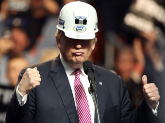 Donald Trump is vowing to save the coal industry. He donned a miner's hat during a recent West Virginia rally. Steve Helber/AP