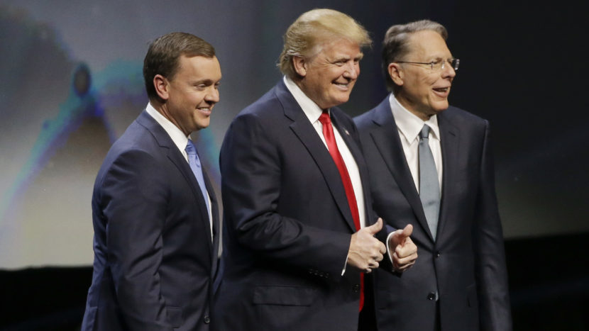 Donald Trump is introduced by National Rifle Association executive director Chris Cox (left) and NRA executive vice president Wayne LaPierre on Friday at the organization's convention in Louisville, Ky. Mark Humphrey/AP