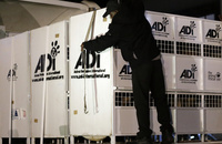 A worker straps down cages that hold former circus lions on their arrival at OR Tambo International airport in Johannesburg. Themba Hadebe/AP