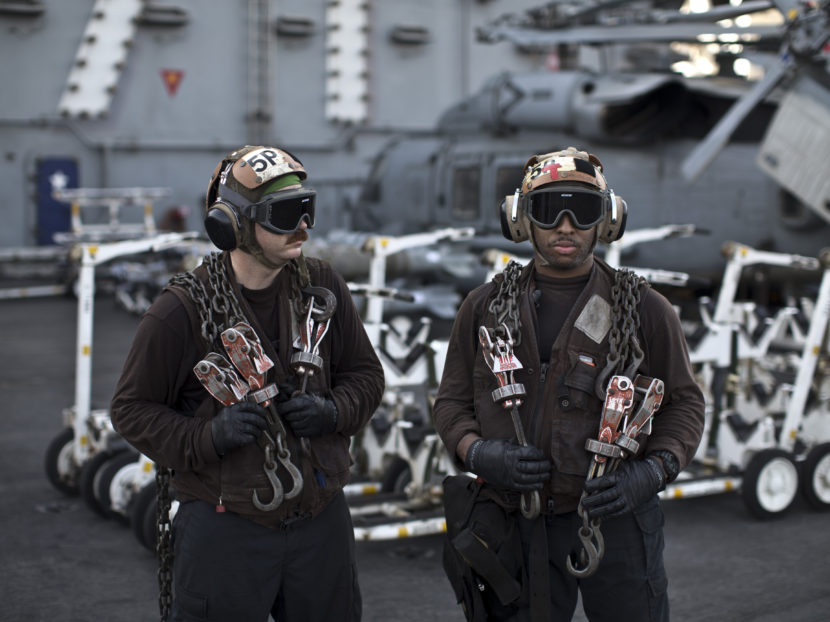 U.S. Navy air wing captains pause on the flight deck of the aircraft carrier USS Theodore Roosevelt last September. Every day, the steam-powered catapult aboard this massive ship flings American fighter jets into the sky, on missions to target the extremist Islamic State group in Iraq and Syria. Marko Drobnjakovic/AP