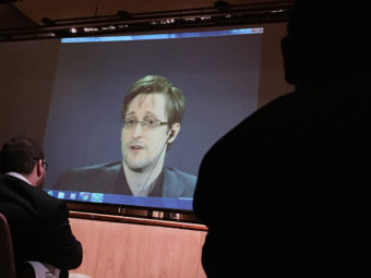 Former National Security Agency contractor Edward Snowden speaks via video conference at Johns Hopkins University in February. Juliet Linderman /AP