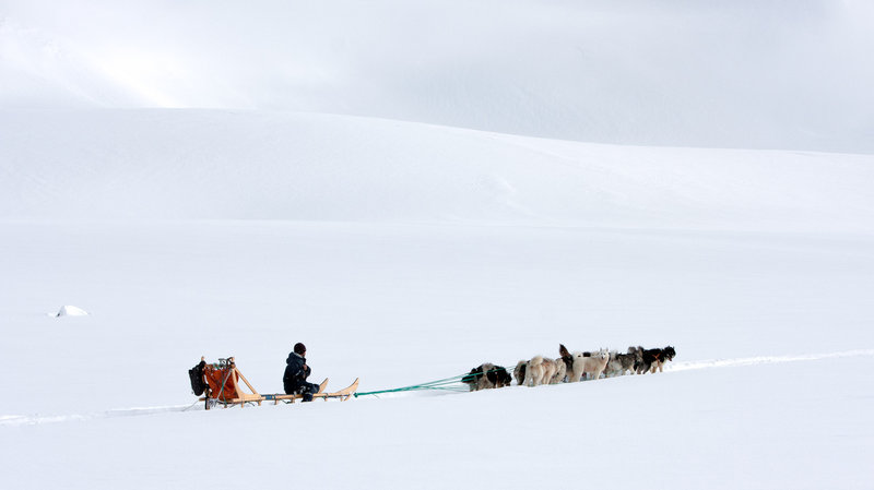 and sled driver approach a glacier outside Tiniteqilaaq. Victor Cerutti