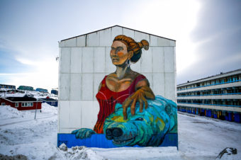 An artist's rendering of the Woman of the Sea, part of an Inuit legend, decorates an apartment block in downtown Nuuk, Greenland. Although Inuit culture was beaten down by Danish colonizers, it's now changing and thriving. John W. Poole/NPR