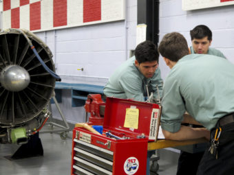 Students work on a reciprocating engine, used for small aircraft. Gabrielle Emanuel/NPR