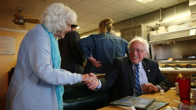 Madonna Rea shakes hands with Democratic presidential candidate Bernie Sanders as he has breakfast at Peppy Grill on Tuesday in Indianapolis. JOE RAEDLE / GETTY IMAGES