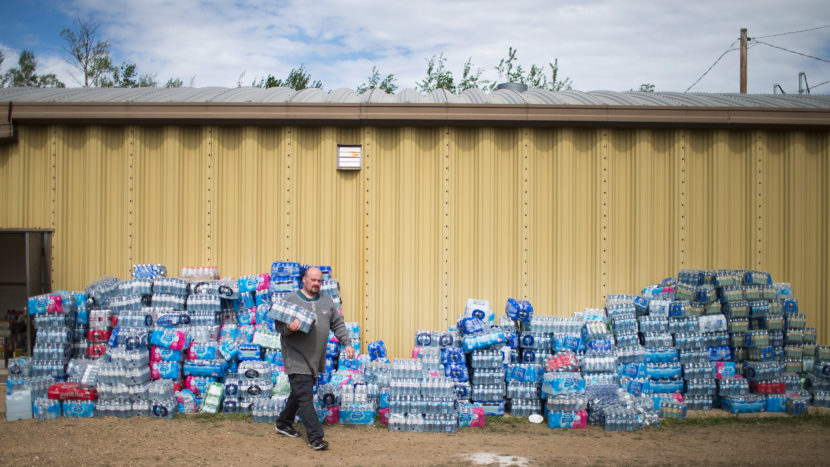 Rodney Howse gets water Sunday at a donation center established to help evacuees forced from their homes by the Fort McMurray wildfire. Wildfires have forced the evacuation of more than 80,000 residents who were living in and around Fort McMurray. Scott Olson/Getty Images