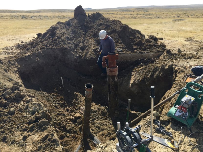 A contractor prepares to cut off the top of a coal bed methane well near Gillette, Wyo., in 2015. It's one of thousands of abandoned, plugged wells sprinkled throughout Wyoming and Colorado. (Photo by Stephanie Joyce/Wyoming Public Media)