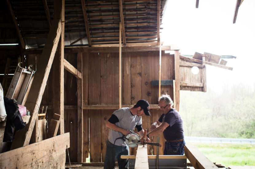 Charles Testerman (left) learns from David Gibney how to restore an early 19th century barn in Waynesboro, Pa. Meredith Rizzo/NPR