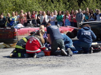 Students watch as EMTS try to revive one of the victims in Thursday’s mock crash. (Photo by Joe Viechnicki/KFSK)
