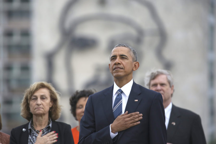 President Obama listens to the U.S. national anthem in Havana on March 21. Behind him is an image of Cuba's revolutionary leader Ernesto "Che" Guevara. (Photo by Dennis Rivera/AP)