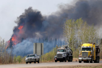 A wildfire burns near Highway 63 south of Fort McMurray, in the Canadian province of Alberta, on Sunday. Chris Wattie/Reuters