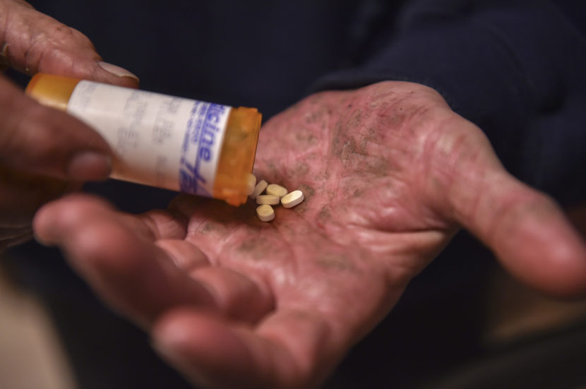 A man in Mt. Airy, Md., shakes Suboxone pills from a bottle in late March. Ricky Carioti/The Washington Post/Getty Images