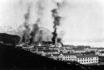 Buildings burning after the first Japanese attack on Dutch Harbor, Alaska (USA), 3 June 1942. (Public Domain photo by U.S. Army)