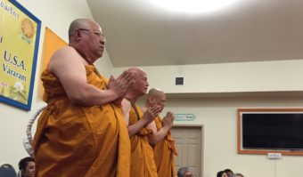 Three new monks wait for questions during the first official Buddhist monk ordination in Alaska. (Photo by Anne Hillman/KSKA)