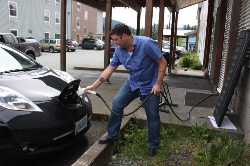 Travis McCain plugs in his 2013 Nissan Leaf. (Photo by Elizabeth Jenkins/KTOO)