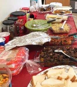 Community members bring food to share during iftar, or the nightly breaking of the fast of Ramadan. (Photo by Anne Hillman/KSKA)