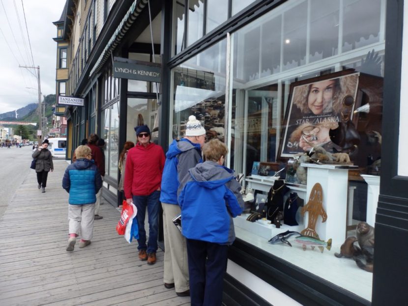 Tourists look in the window of Lynch and Kennedy Dry Goods in May 2016. (Photo by Emily Files/KHNS)