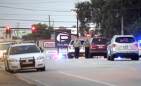 Police cars surround the Pulse Orlando nightclub, the scene of a fatal shooting, in Orlando, Fla. (Phelan M. Ebenhack/AP)