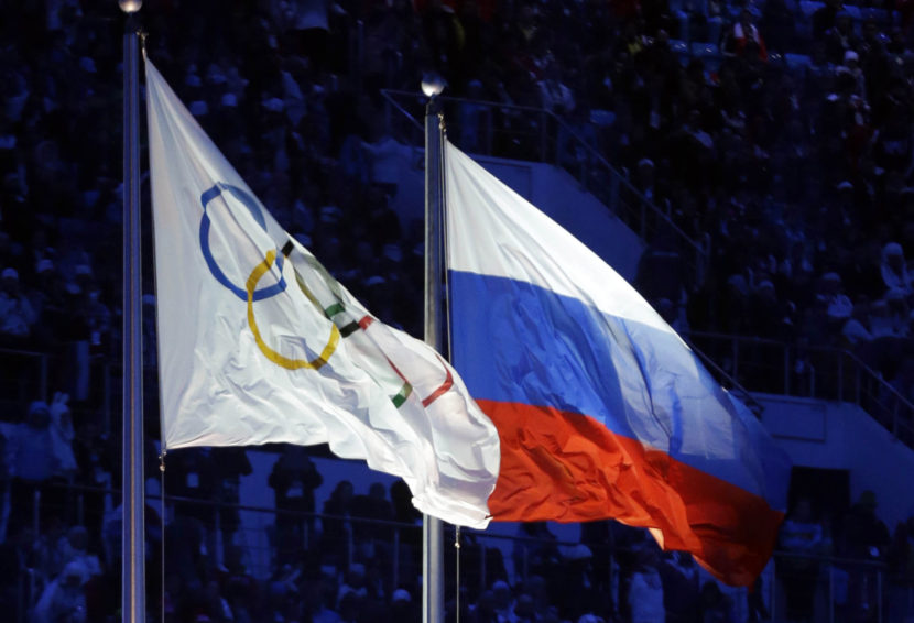 The Russian and the Olympic flags wave during the opening ceremony of the 2014 Winter Olympics in Sochi, Russia. Patrick Semansky/AP