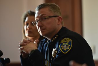 Oakland Police Chief Sean Whent, with Mayor Libby Schaaf behind him, listens to questions from the media on May 2, 2015, after May Day protests in Oakland, Calif. Whent has since resigned as police chief — as did two interim chiefs after him, over the course of a little more than a week. Josh Edelson/AFP/Getty Images