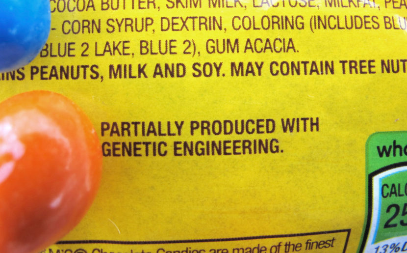 A new disclosure statement on a package of peanut M&Ms candy notes they are "partially produced with genetic engineering." (Photo by Lisa Rathke/AP)