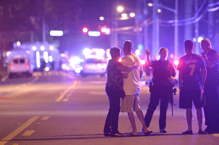 Orlando police officers direct family members away from a shooting at a nightclub in Orlando, Fla., on Sunday. (Phelan M. Ebenhack/AP)